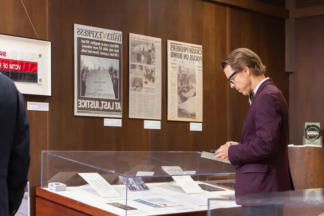 Person looking over archival museum materials.